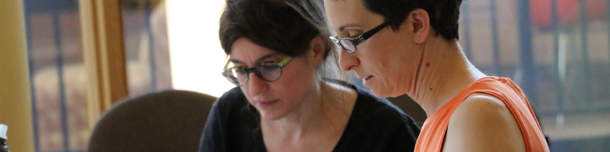 Two women reviewing documents together