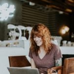 Person smiling at computer