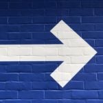 Arrow on blue wall pointing right