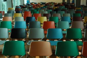 Rows of empty chairs of various colors